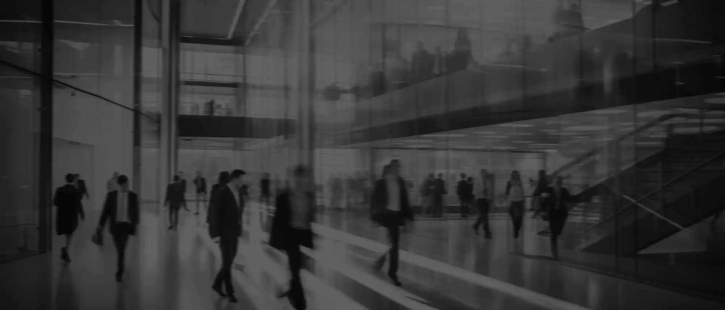 Business people walk in a large office lobby against a cityscape background. Motion blur effect, bright business workplace with people in walking in blurred motion in modern office space